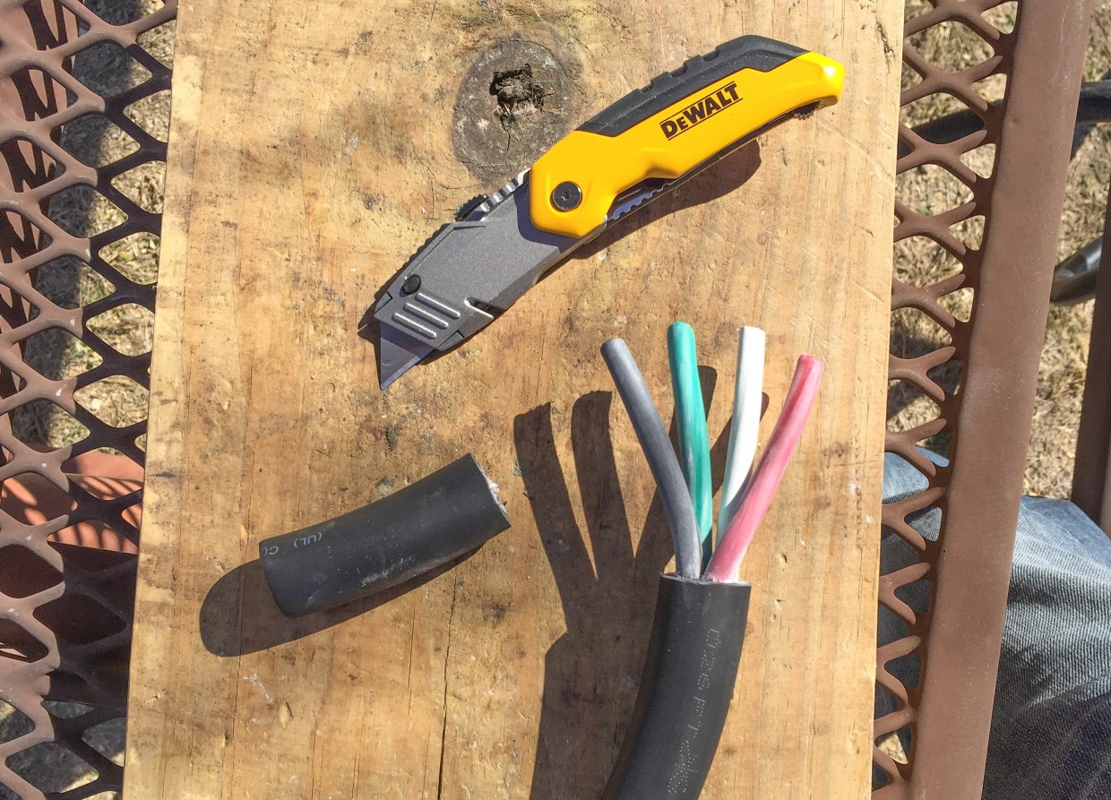 Stripping 3" of outer insulation off the 6--4 cable.