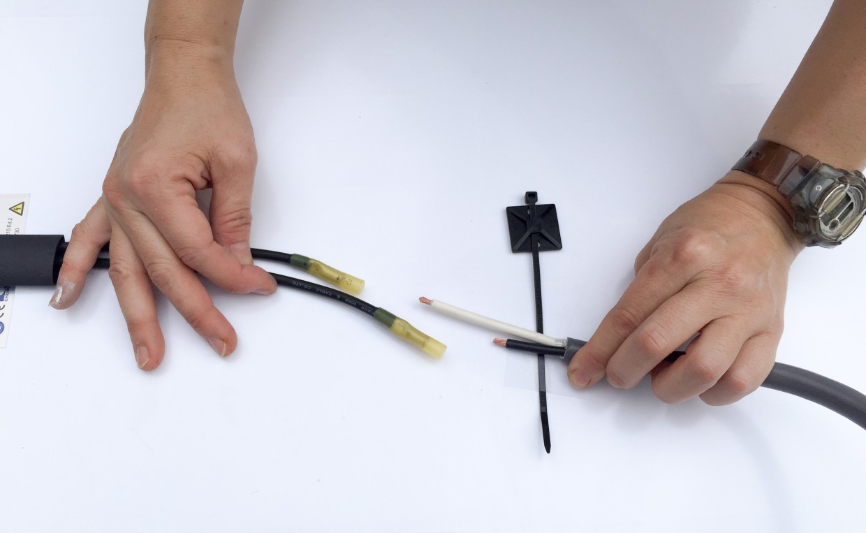 Connecting the panel's output wires to our rooftop wires.